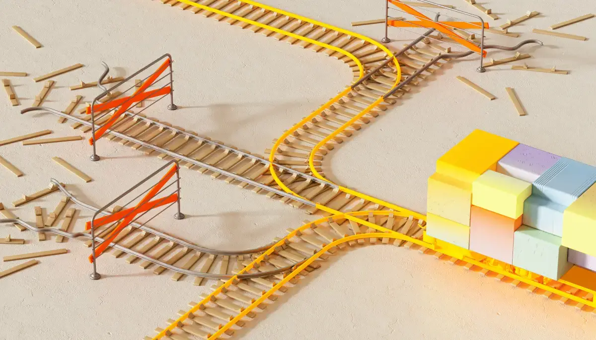 Branching yellow and orange railway tracks weaving through a pale architectural model