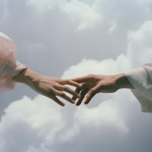 Two hands reaching towards each other against a cloudy sky