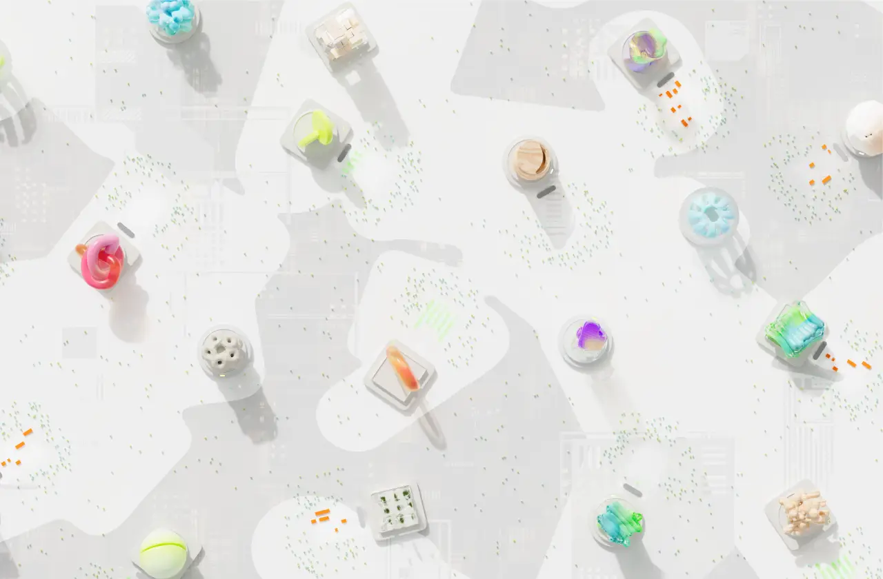 Overhead arrangement of colourful abstract objects on separate white geometric platforms